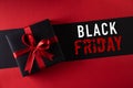 Top view of black christmas boxes with red ribbon on black background with copy space for text. black Friday and Boxing Day Royalty Free Stock Photo