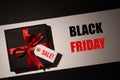Top view of black christmas boxes with red ribbon on black background with copy space for text. black Friday and Boxing Day Royalty Free Stock Photo
