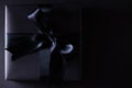 Top view of black christmas boxes with red ribbon on black background with copy space for text. black Friday composition Royalty Free Stock Photo