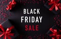 Top view of black christmas gift boxes with red ribbon on black background with text Bkack Friday Sale composition Royalty Free Stock Photo