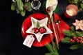 Top view of black Christmas table with red plate and white star shaped bowl and copy space Royalty Free Stock Photo