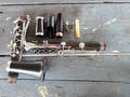 Top view of black clarinet instrument, jazz instrument, instrument repair concept, dismantled and placed on a wooden table. Royalty Free Stock Photo