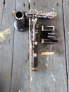 Top view of black clarinet instrument, jazz instrument, instrument repair concept, dismantled and placed on a wooden table. Royalty Free Stock Photo