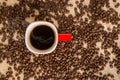 Top view of black coffee in red cup on burlap sack background Royalty Free Stock Photo