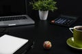 Top view, black desk with computer graph, magnifier and calculator