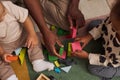 Top view Black father with two children playing with wooden toys together Royalty Free Stock Photo