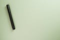 Top view of a black felt-tip pen on pastel green background Royalty Free Stock Photo