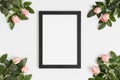 Top view of a black frame mockup with pink roses decoration Royalty Free Stock Photo