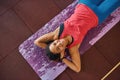 Top view of black girl laying on fitness mat Royalty Free Stock Photo