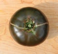 A Top View of a Black Heirloom Tomato with a Long Crack