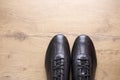 Black leather men shoes on wooden background Royalty Free Stock Photo