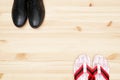 Top view of black leather shoes and beach slippers on wooden background Royalty Free Stock Photo