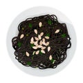 Top view of black long pasta with almond shavings and herbs in plate isolated on white background.