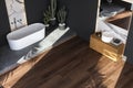 Top view of black and marble bathroom interior with a white bathtub standing on a concrete platform. Royalty Free Stock Photo