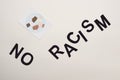 Top view of black no racism lettering and picture with multiethnic hands