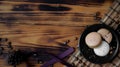 Top view of black plate of coffee macarons on bamboo maton rustic table