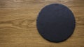 Top view of black slate round stone on wooden background with copy space Royalty Free Stock Photo