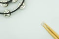 Top view of black tambourine and drumsticks on white background with space in the middle Musical instrument concept Royalty Free Stock Photo