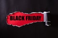 Top view of Black torn paper and the text black friday on a red background. Black Friday composition