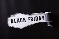 Top view of Black torn paper and the text black friday on a white background. Black Friday composition