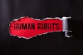 Top view of Black torn paper and the text HUMAN RIGHTS on a red background. Human rights concept Royalty Free Stock Photo