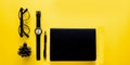 Top view. Black vintage glasses and book and watch. Minimal Style on yellow background use for wallpaper and screen