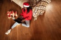 Top view of black woman with laptop doing online Xmas shopping, sitting on floor at home, mockup for website Royalty Free Stock Photo