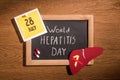 top view of blackboard with lettering world hepatitis day liver pills and stick it with lettering 28th july