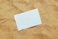 Top view of blank business card in hot beach sand Royalty Free Stock Photo