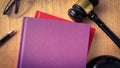 Top view of blank cover book with gavel as background. Royalty Free Stock Photo