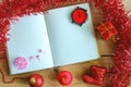 Blank diary notebook with Christmas and New Year ornaments and decoration on wooden table, red color theme Royalty Free Stock Photo