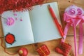 Blank diary notebook with Christmas and New Year ornaments and decoration on wooden table, red color theme Royalty Free Stock Photo