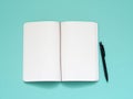 Top view of blank note paper with pen on aqua table Royalty Free Stock Photo