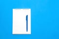 Top view of blank note paper with pen on blue wood table for background. Royalty Free Stock Photo