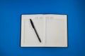 Top view of blank note paper with pen on blue wood table for background. Back to school and education concept Royalty Free Stock Photo