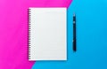 Top view blank notebook and black pen for mockup flat lay on blue and pink background Royalty Free Stock Photo