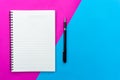 Top view blank notebook and black pen for mockup flat lay on blue and pink background Royalty Free Stock Photo