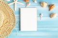 Top view of blank notebook on blue wood table, sea shells and starfish on a blue wooden background, Summer concept Royalty Free Stock Photo