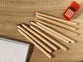 Top view of blank notebook, calculator and pencils on wooden background. Office stationery. School supplies for the student. Royalty Free Stock Photo