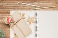 Top view of blank notebook on wood  background with Giftbox and Christmas ornaments decorations. Mockup xmas background with Royalty Free Stock Photo