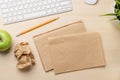 Top view of blank notepad, keyboard, apple and crumpled papers Royalty Free Stock Photo