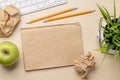 Top view of blank notepad, keyboard, apple and crumpled papers Royalty Free Stock Photo