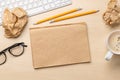 Top view of blank notepad, keyboard, coffee, apple and crumpled papers Royalty Free Stock Photo