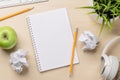 Top view of blank notepad, keyboard, headphones, apple and crumpled papers Royalty Free Stock Photo