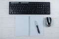 Top view of a blank notepad with a pen, keyboard and computer mouse Royalty Free Stock Photo