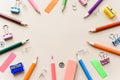 Top view blank office desk table with empty space on pastel beige backgroud. Flat lay. Paper clips, sharpener, pencils, stickers