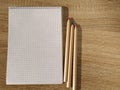 Top view of blank open notebook and pencils on wooden background. Office stationery. School supplies for the student. Education Royalty Free Stock Photo
