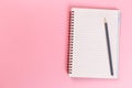 Top view of blank open notebook on pink background, concept of education or new workplace Royalty Free Stock Photo