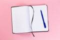 Top view of blank open notebook on pink background, concept of education or new workplace Royalty Free Stock Photo