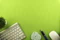 Top view of blank paper page on green background office desk and different objects. Minimal flat lay style Royalty Free Stock Photo